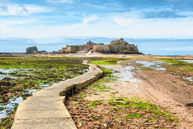 Low tide footpath leading to Elizabeth Castle, off the coast of Saint Helier,  Jersey, Channel Islands, UK.