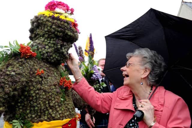 Tradition dictates that the Burryman accepts nips of whisky during his nine-hour tour of the village. PIC: Lisa Ferguson/TSPL.