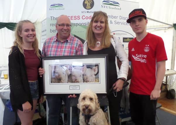 Celebrating his Unsung Hero award at Turriff Show was well known pig producer Kevin Gilbert (centre) accompanied by his wife Anna, daughter Elizabeth and son Thomas. Even Jazzer the family dog joined in the celebrations.