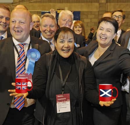 All smiles: John McLellan, left, celebrates with Ashley Graczyk and Ruth Davidson after the former two were elected as Conservative councillors (Picture: Neil Hanna)