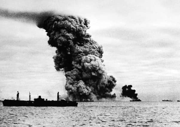 An Arctic convoy ship burns after being hit by a bomb in the waters north of the Arctic Circle. Picture: Rex/Shutterstock