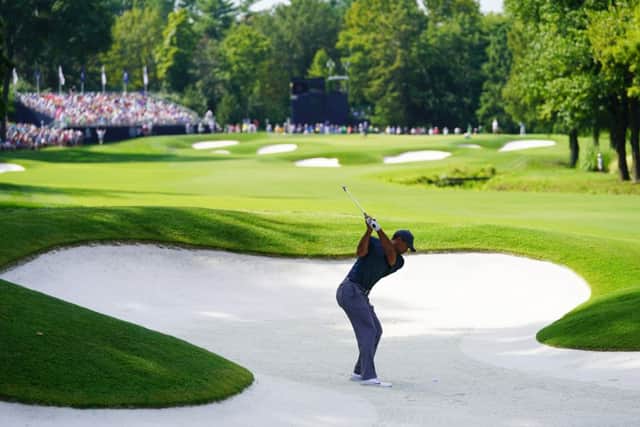 Tiger Woods plays out of a bunker on the 17th hole on the opening day of the 100th US PGA Championship yesterday. Picture: Getty