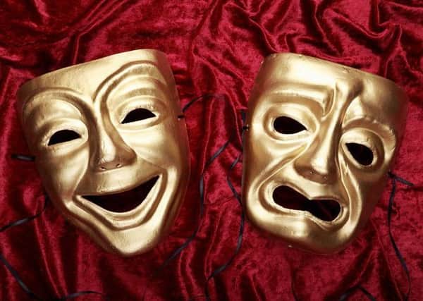 Tragicomedy masks on red velvet