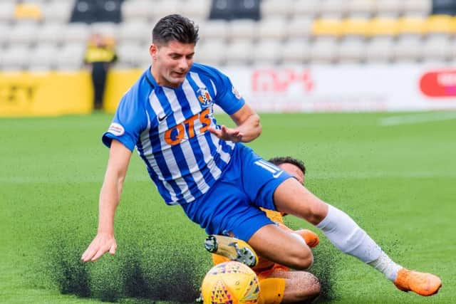 Kilmarnock's Jordan Jones is tackled by Livingston's Egli Kaja. Pic: SNS/Ian Georgeson