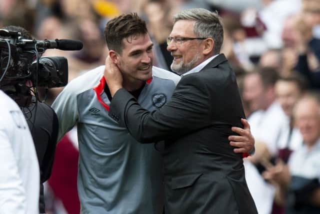 Kyle Lafferty with manager Craig Levein after the striker's goal was enough to defeat Celtic at Tynecastle. Picture: SNS