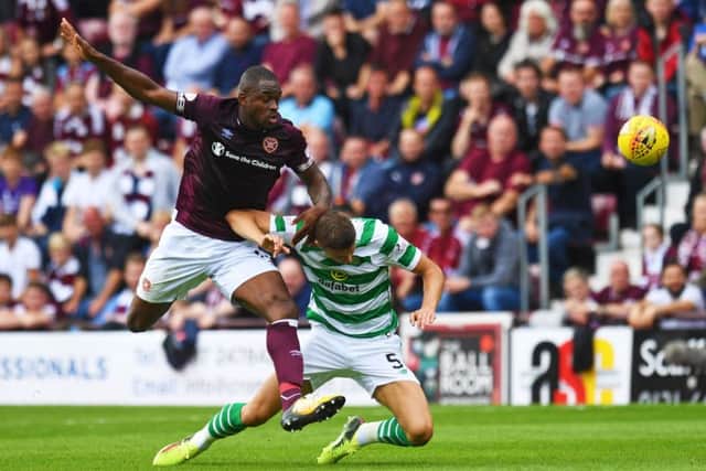 Uche Ikpeazu and Jozo Simunovic in action as the Hearts forward has an attempt on goal. Pic: SNS/Craig Williamson