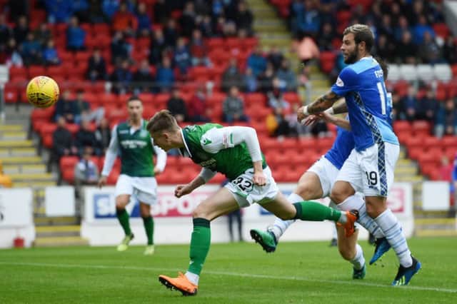 Oli Shaw stoops to head Hibs back on level terms. Picture: SNS