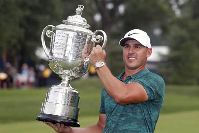 Brooks Koepka holds the Wanamaker Trophy after winning the US PGA Championship at Bellerive Country Club in St Louis. Picture: AP