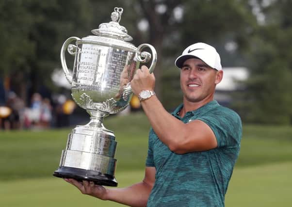 Brooks Koepka holds the Wanamaker Trophy after winning the US PGA Championship at Bellerive Country Club in St Louis. Picture: AP