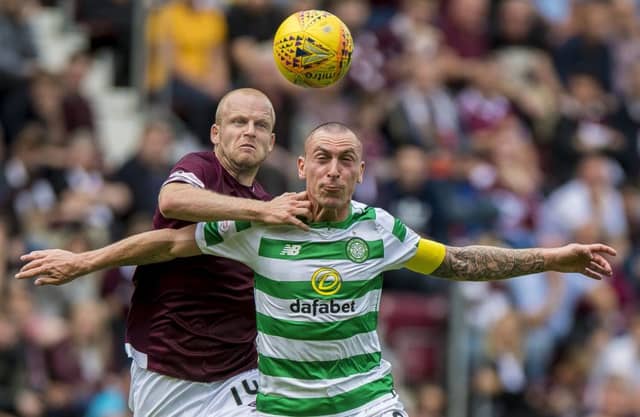 Steven Naismith and Celtic's Scott Brown battle for possession during Hearts' victory at Tynecastle. Picture: PA