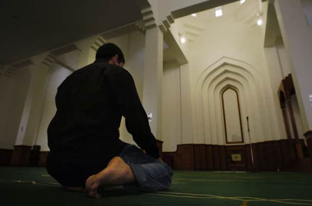 A man prays at a mosque in Edinburgh. Around 77,000 Muslims live in Scotland. Picture: Robert Perry