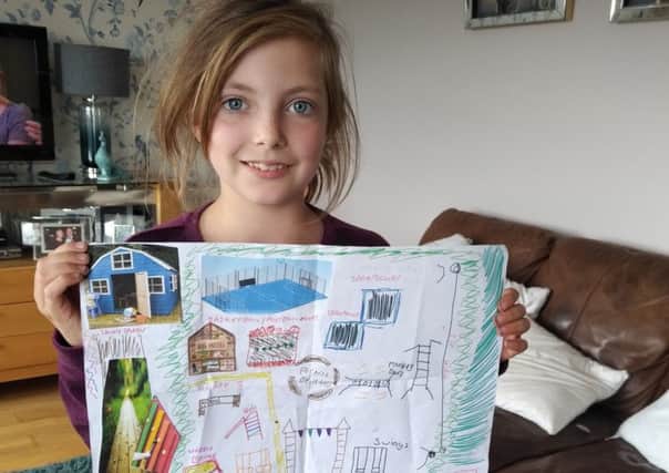 Grace Kenny shows off her winning entry in the Rennie Road Community Alliance design your play park competition