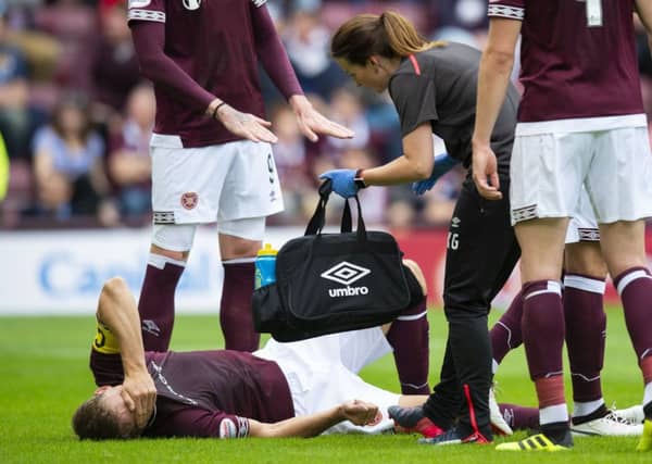 Christophe Berra suffered the injury in the first half of the match and was stretchered off. Picture: SNS Group