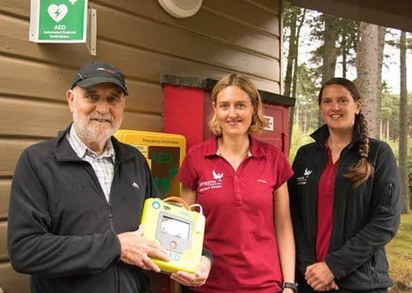 Kenneth Cooper is pictured with volunteer rangers Keira Macfarland and Leo Hunt.