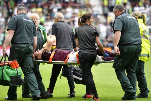 Agony for Hearts captain Christophe Berra as he is stretchered off during Saturdays victory over Celtic with  a torn hamstring. Picture: SNS.