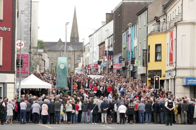 People gathering on Market Street, Omagh, during the ceremony . Picture: Niall Carson/PA Wire