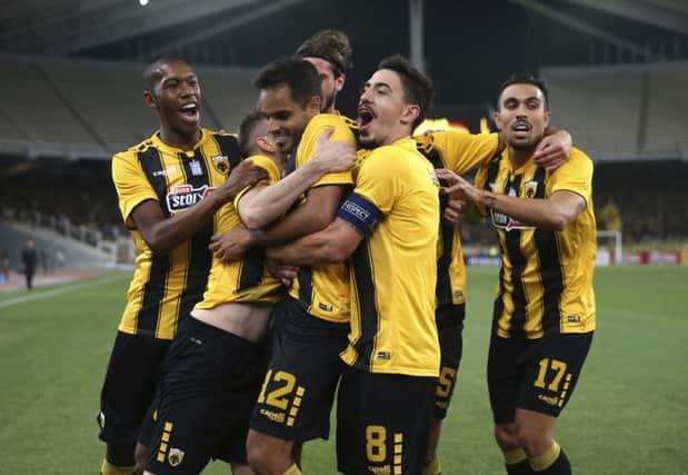 Rodrigo Galo, center, celebrates with his AEK Athens team-mates after giving the hosts the lead. Picture: AP