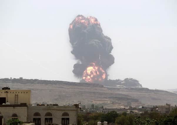 An air strike by the Saudi-led coalition on a target in Huthi rebel-controlled Yemen sends a fireball high into the sky (Picture: Mohammed Huwais/AFP/Getty Images)