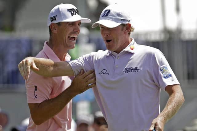 Brandt Snedeker, right, celebrates with playing partner Billy Horschel, left, after making a birdie putt on the ninth hole at the Wyndham Championship in Greensboro. Sneaker shot a 59 in the first round. Picture: Chuck Burton/AP
