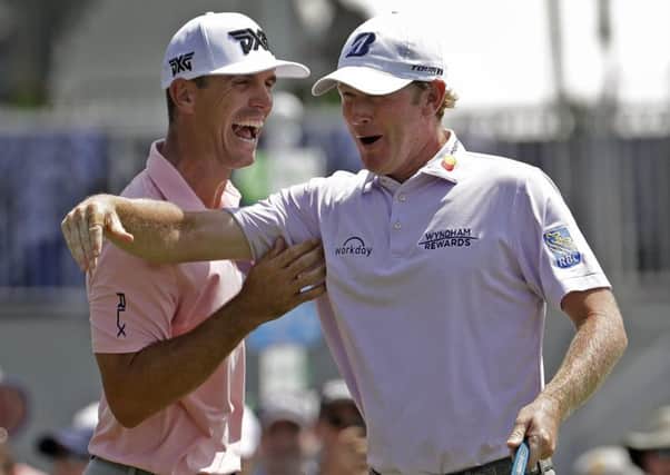 Brandt Snedeker, right, celebrates with playing partner Billy Horschel, left, after making a birdie putt on the ninth hole at the Wyndham Championship in Greensboro. Sneaker shot a 59 in the first round. Picture: Chuck Burton/AP
