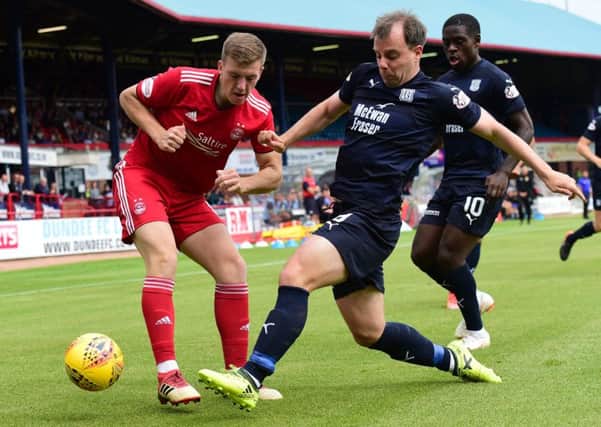 Lewis Ferguson of Aberdeen in action against Dundee's Paul McGowan. Picture: