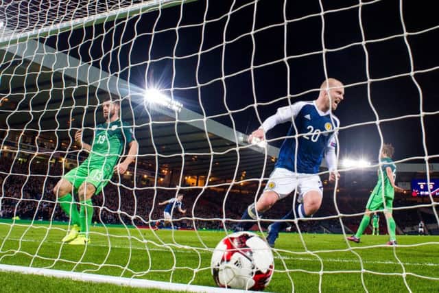 Steven Naismith watches on as Chris Martin's strike finds the net against Slovenia at Hampden