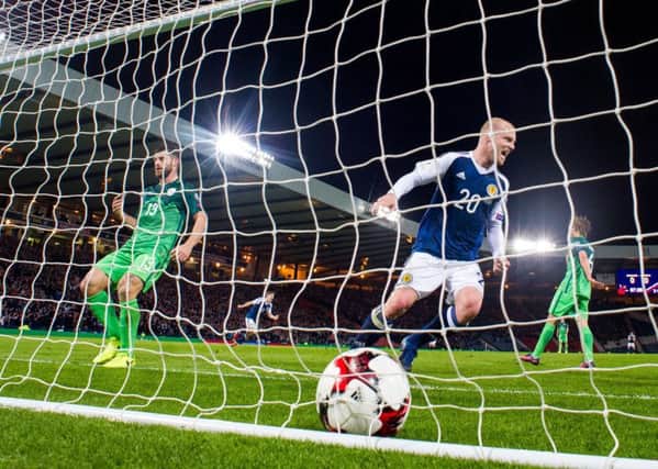 Steven Naismith watches on as Chris Martin's strike finds the net against Slovenia at Hampden