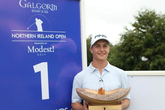 Calum Hill holds the trophy after winning the Northern Ireland Open.