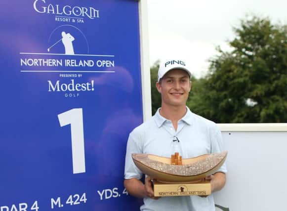 Calum Hill holds the trophy after winning the Northern Ireland Open.