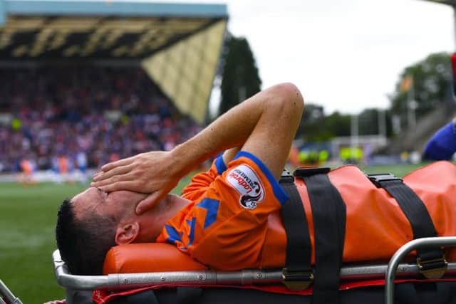 Agony for Jamie Murphy as he is carried off at Rugby Park on a stretcher. Picture: SNS.