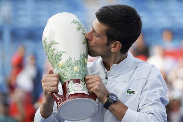 Novak Djokovic plants a big kiss on the Rookwood pottery trophy after his victory over Roger Federer in Cincinnati on Sunday. Picture: AP.