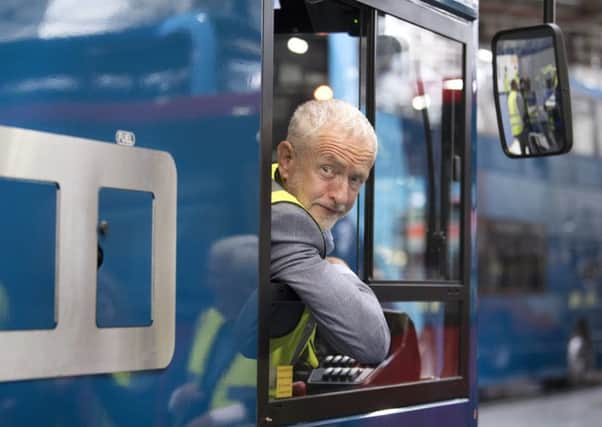 Jeremy Corbyn leans from the cab of a bus during a visit to the Alexander Dennis bus manufacturer Alexander Dennis bus manufacturers in Falkirk. Picture: John Devlin.