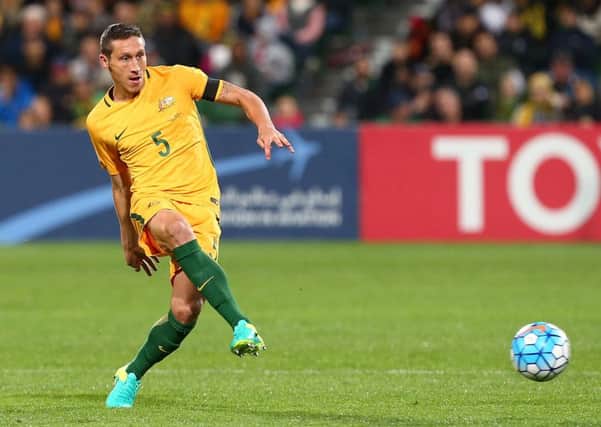 Graham Arnold is hopeful Mark Milligan will U-turn on his decision to hang up his international boots. Picture: Getty Images