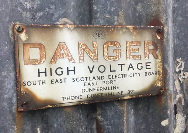 An old electric company sign rusts, but change is coming to the industry