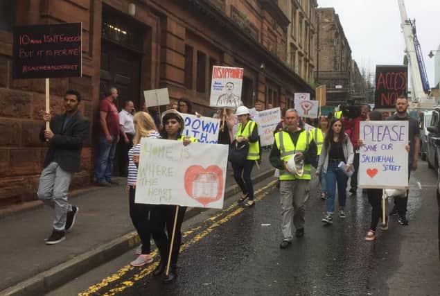 Business owners and residents gather to protest at the lack of access to their properties since last month's Glasgow School of Art fire in the historic Mackintosh Building in Glasgow.