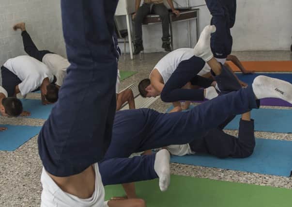 Teenagers facing homicide and robbery charges practise yoga in a young offenders' institution in Mexico (Picture: Omar Torres/AFP/Getty)