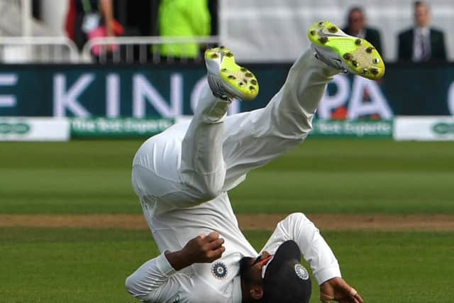India's Ajinkya Rahane tumbles backwards after catching James Anderson in the slips. Picture: Paul Ellis/AFP/Getty