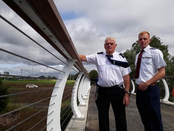 Glasgow Humane Society officers George Parsonage and William Graham beside  the curved parapet and lighting inset in the top rail. Picture: The Scotsman