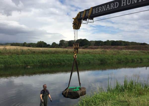 The Pictish symbol stone being raised from the water at Dyce, Aberdeen. PIC: HES.