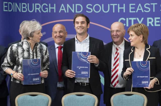 Prime Minister Theresa May, City of Edinburgh Council leader Adam McVey and First Minister Nicola Sturgeon after signing the Edinburgh and South East Scotland City Region Deal at the University of Edinburgh. Picture: PA