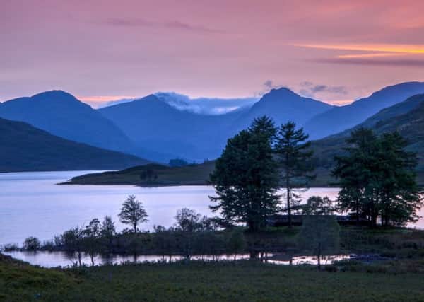 The last light of the day illuminates the sky above Loch Arklet overlooking Ben Vorlich & Ben Ime in the Loch Lomond & Trossachs national Park. Picture: SWNS