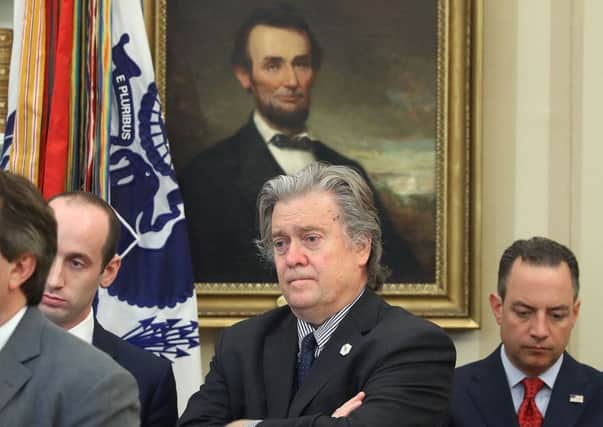 Steve Bannon listens to a speech by Donald Trump in the White House, beneath a portrait of Abraham Lincoln (Picture: Mark Wilson/Getty)
