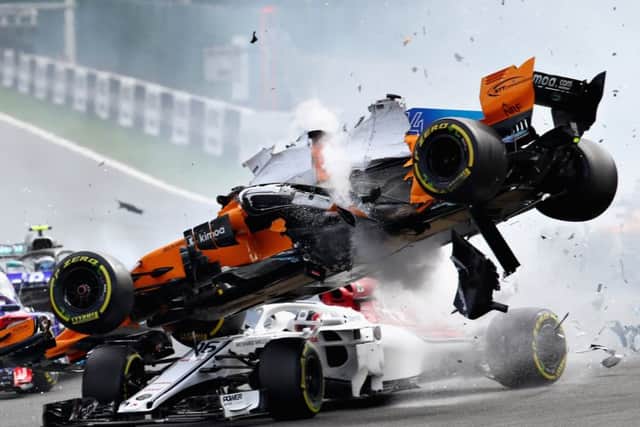 The right front tyre of Fernando Alonso's McLaren hit the 'halo' protecting Charles Leclerc's head. Picture: Mark Thompson/Getty