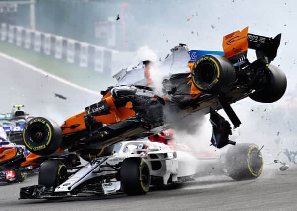 The right front tyre of Fernando Alonso's McLaren hit the 'halo' protecting Charles Leclerc's head. Picture: Mark Thompson/Getty