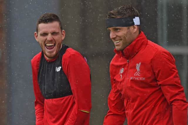 James Milner shares a joke with Andy Robertson, left, during Liverpool training. Picture: Liverpool FC via Getty.