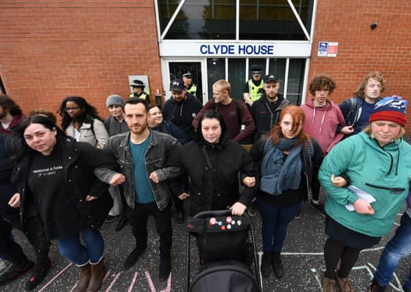 Campaigners form human chain outside Serco in solidarity with asylum seekers in Glasgow. Picture: John Devlin