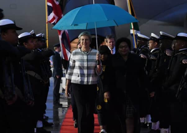 Prime Minister Theresa May walks with Nomvula Mokonyane - the South African Minister of Communications - as she arrives at Cape Town airport. Picture: Stefan Rousseau/PA Wire