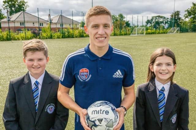Rangers star Greg Docherty launches his new Football Academy at Douglas Academy, with the help of pupils Reiss Weir and Marnie Sayer