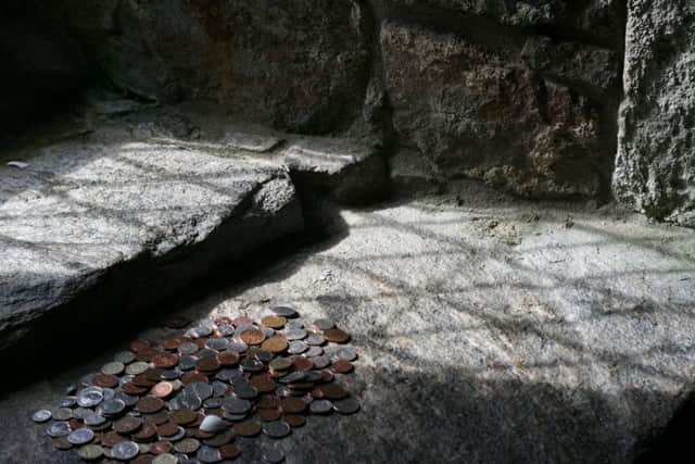 Coins and a shell left as offerings at St Clements on Harris. PIC: Savagecat/Flickr/CreativeCommons