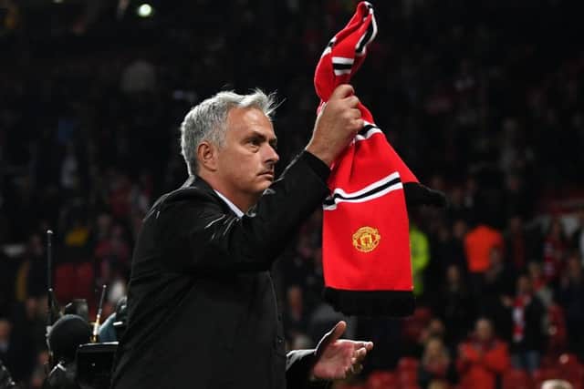 Jose Mourinho waves a Manchester United scarf towards fans after his side's 3-0 defeat by Tottenham Hotspur at Old Trafford. Picture: Michael Regan/Getty